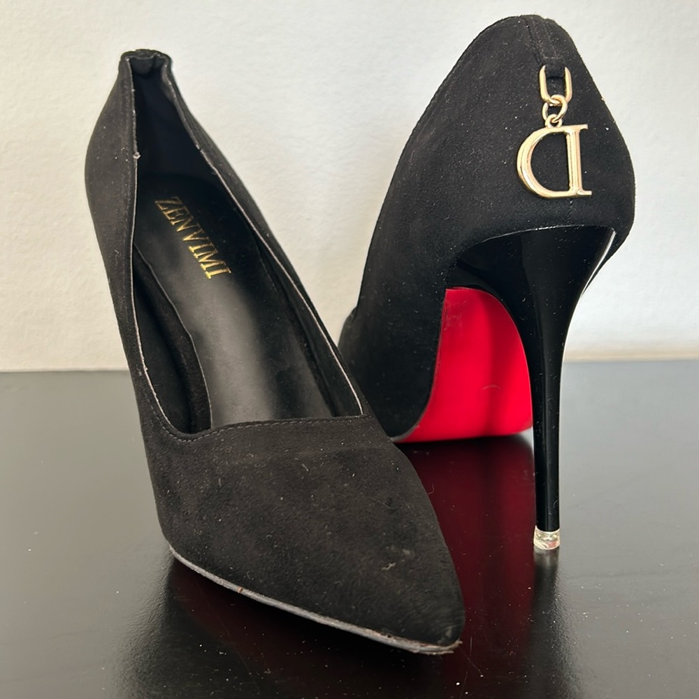 Black suede heels with red bottom